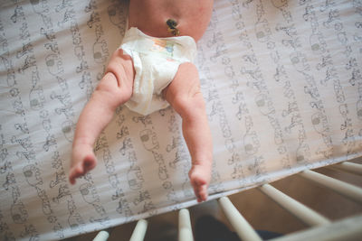 Low section of child standing on tiled floor