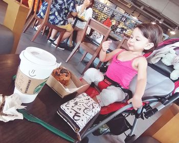 High angle view of cute girl sitting on floor
