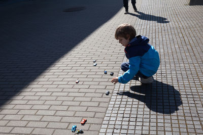 High angle view of boy playing on street