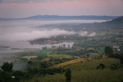 Scenic view of landscape against sky during foggy weather