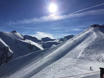 Scenic view of snow covered mountains against sky