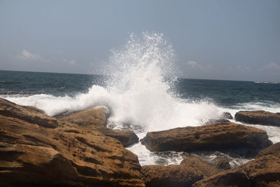 Waves splashing on rocks at shore