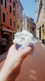 Close-up of hand holding ice cream