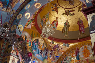 Low angle view of statues on ceiling in building