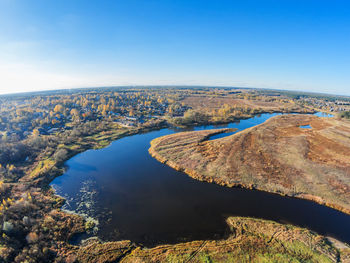 Aerial view of landscape against blue sky