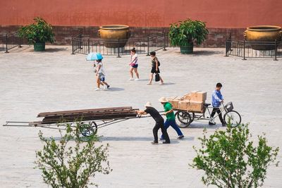 People walking on sidewalk in city