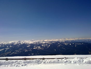 Scenic view of snow covered mountains against clear sky