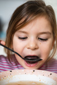 Close-up of girl eating food