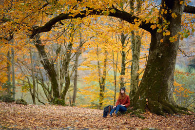 Man sitting in park during autumn