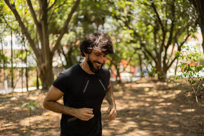 Man running and jogging at a park outdoors. male person workout. feel good, healthy concept. 