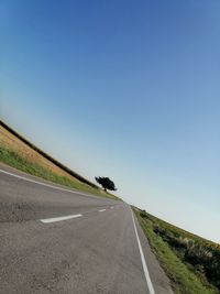 Empty road against clear sky