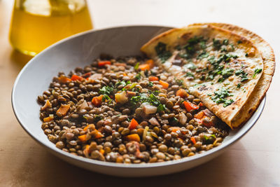 Lentils homemade vegan dish with vegetables and carrots and smoke, 