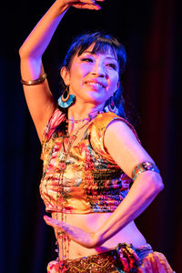 Portrait of a smiling young woman dancing