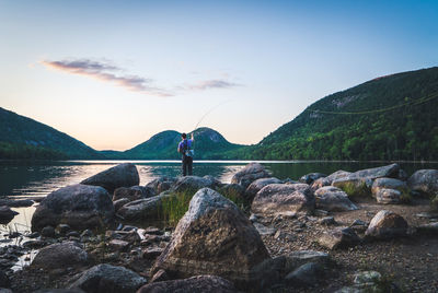 Man fishing at sunset at jordan pond, acadia national park