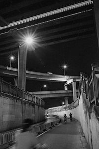 Illuminated tunnel at night