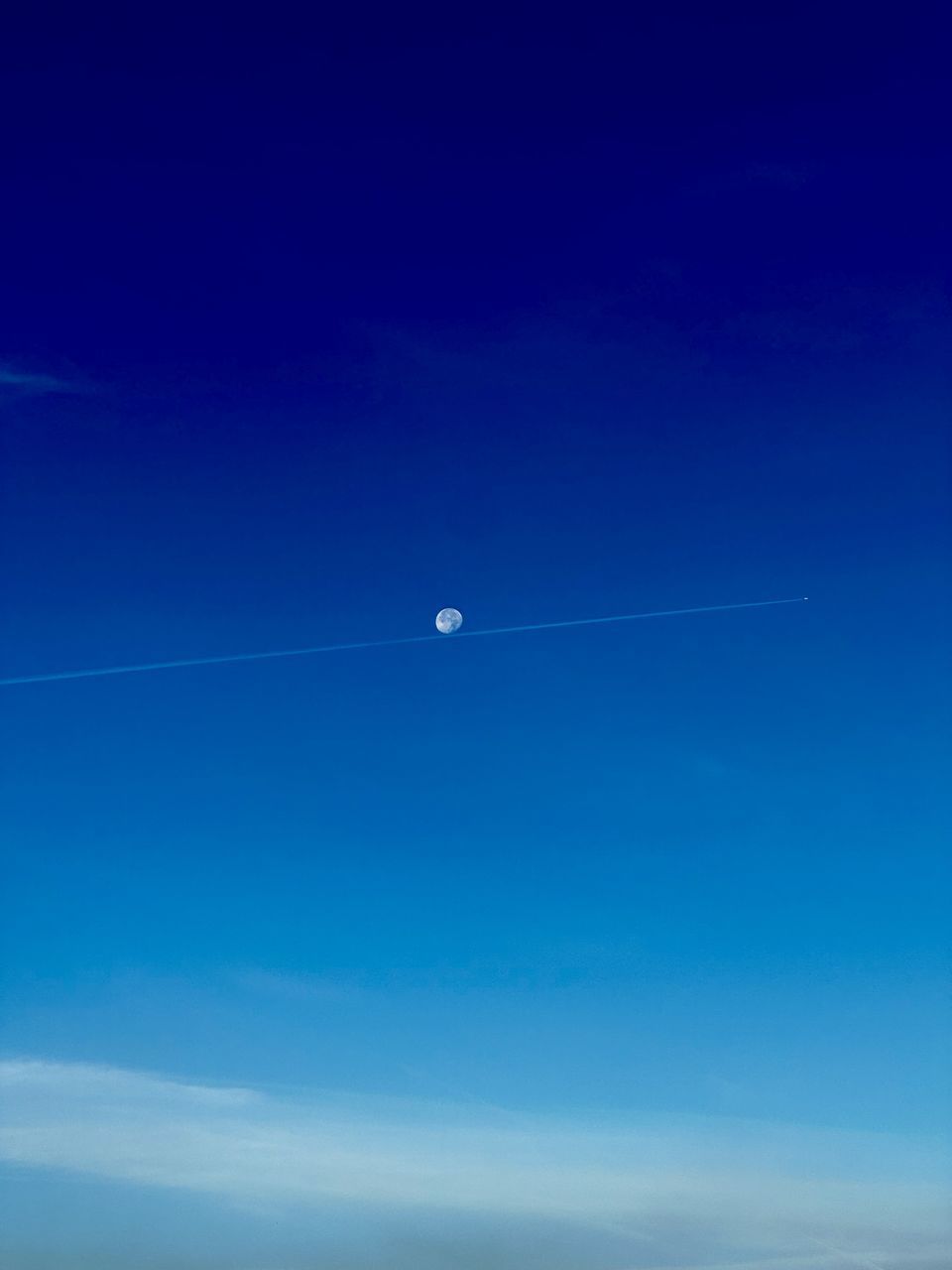 sky, blue, horizon, cloud, flying, nature, scenics - nature, beauty in nature, no people, vapor trail, air vehicle, tranquil scene, tranquility, copy space, mid-air, low angle view, clear sky, transportation, outdoors, moon, day, airplane, astronomical object, distant, motion, dawn, environment
