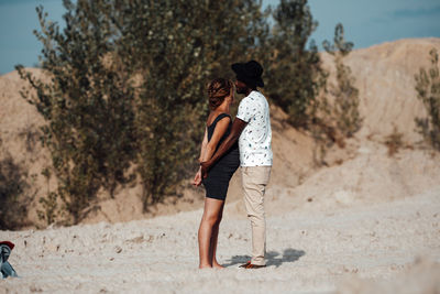 Rear view of couple standing on land