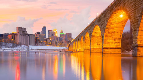 View of bridge over river against buildings