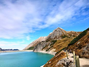 Scenic view of sea and mountains against sky