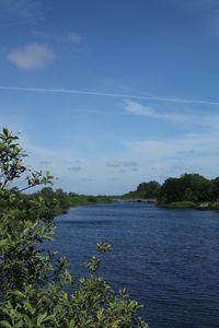 Scenic view of lake against blue sky