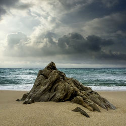 Scenic view of sea against cloudy sky