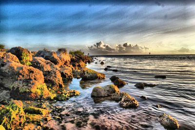 Scenic view of sea against cloudy sky