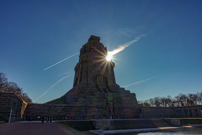 Low angle view of statue against blue sky