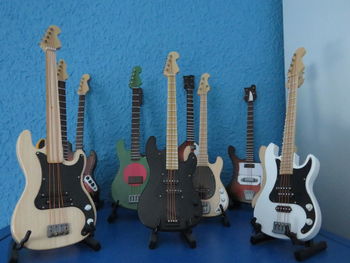 Colorful electric guitars against wall