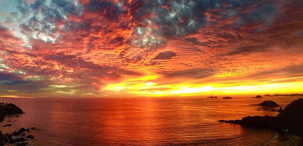 Scenic view of sea against romantic sky at sunset