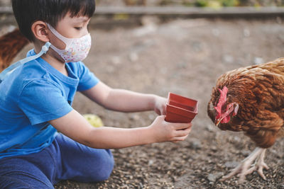 Portrait of cute girl feeding bird