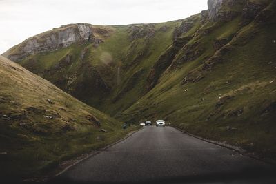 Road amidst mountains against sky