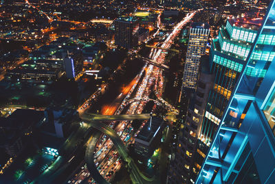 High angle view of illuminated modern buildings in city at night