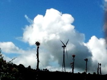 Low angle view of windmill against cloudy sky