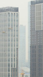 Modern buildings in city against sky