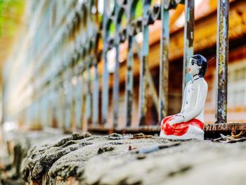 Close-up of toy on railing