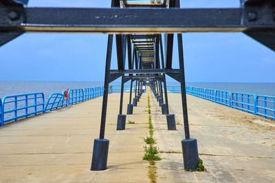 Pier over sea against sky