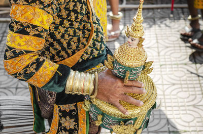 Midsection of man wearing traditional clothing