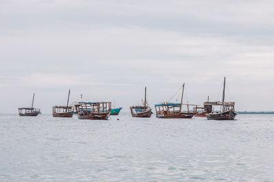 Boats in sea against sky