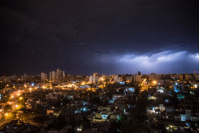 High angle view of illuminated city against sky at night