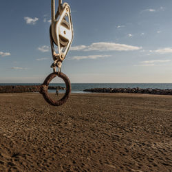 Bicycle on beach against sky