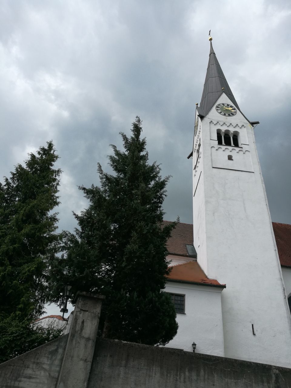 LOW ANGLE VIEW OF BELL TOWER AND TREES AGAINST SKY