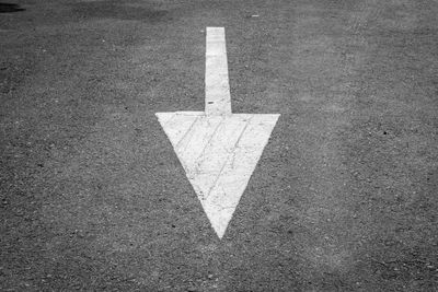 High angle view of arrow sign on road