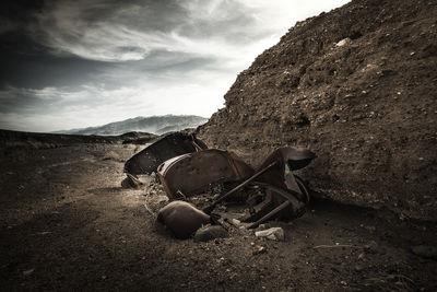 Motorcycle on rock against sky