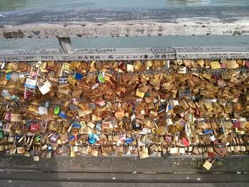 Padlocks hanging on railing at beach