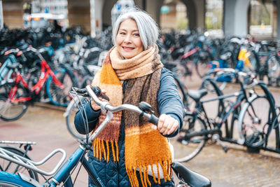 Portrait of smiling woman with bicycle