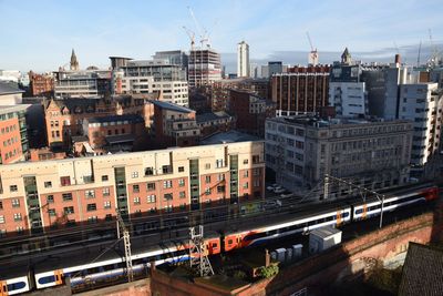 High angle view of buildings in city against sky