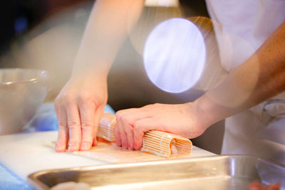 Midsection of man preparing food on table