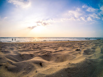 Scenic view of beach against sky during sunset