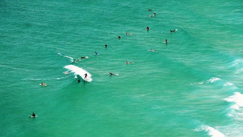 High angle view of people swimming in sea