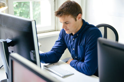 Man working on table in office